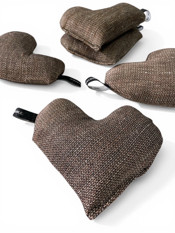 Small heart shaped warm pillow in brown